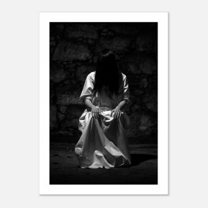 High-resolution black and white photography of scary looking woman sitting on the chair